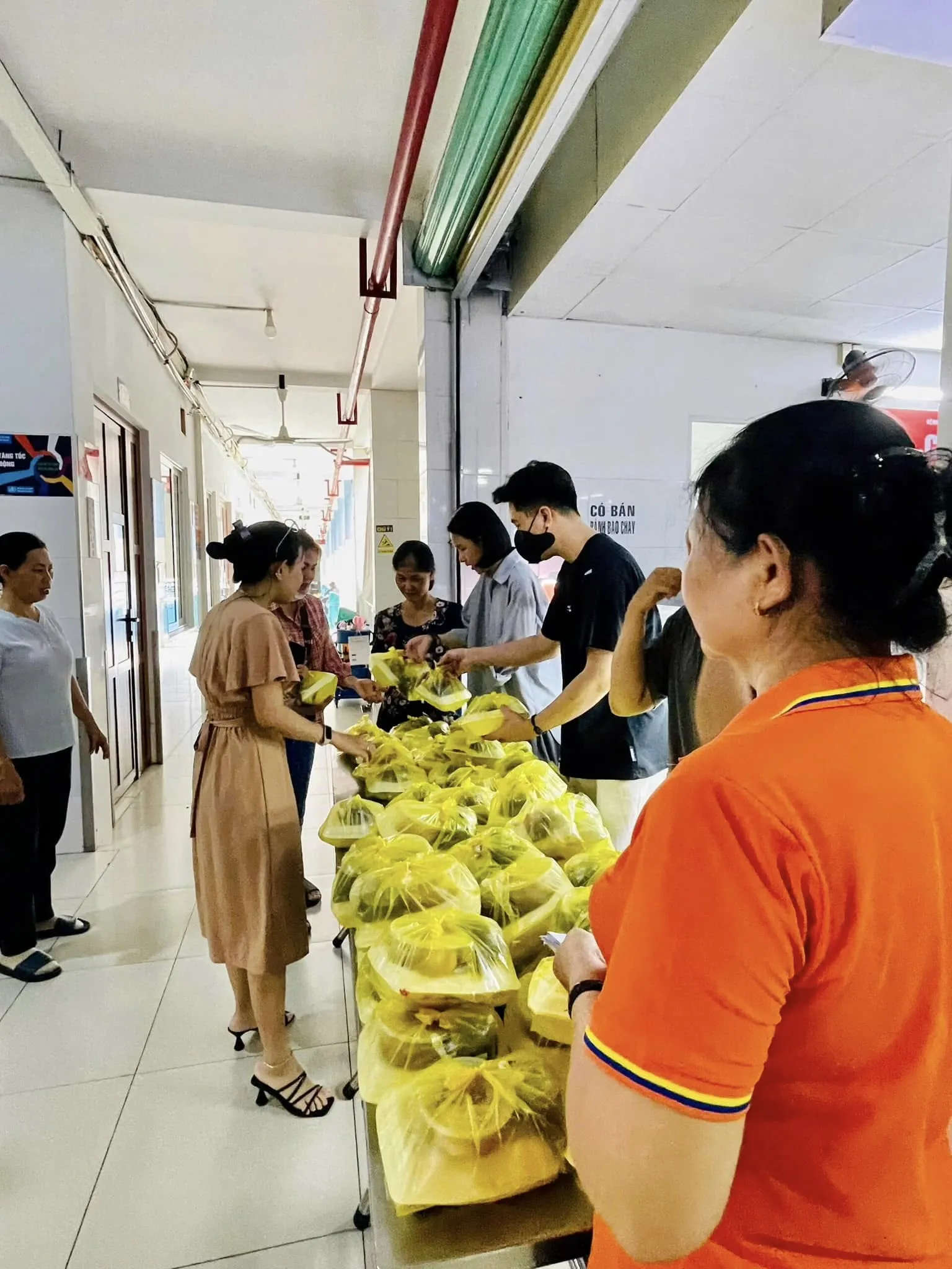 People coming to the table to receive lunch from the volunteers
