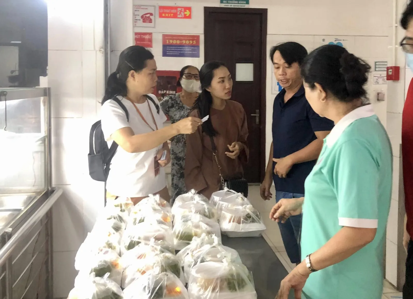 志愿者们在餐桌旁与人们交谈